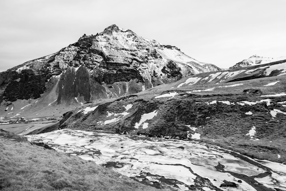 a black and white photo of a snow covered mountain