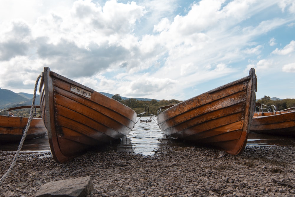 a couple of boats sitting on top of a beach