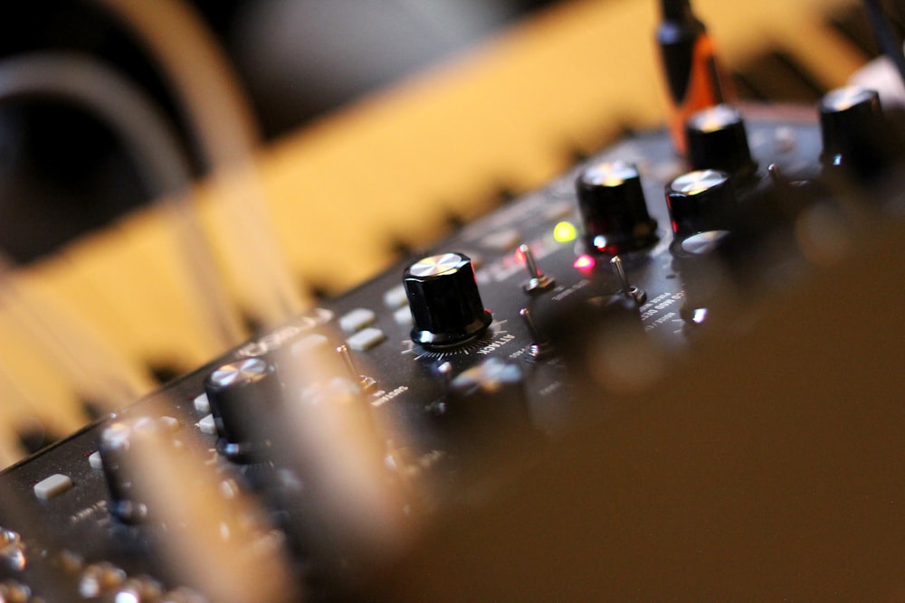 a close up of a sound board with knobs