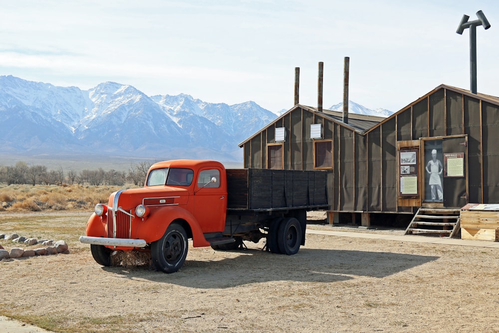 an orange truck parked in front of a building