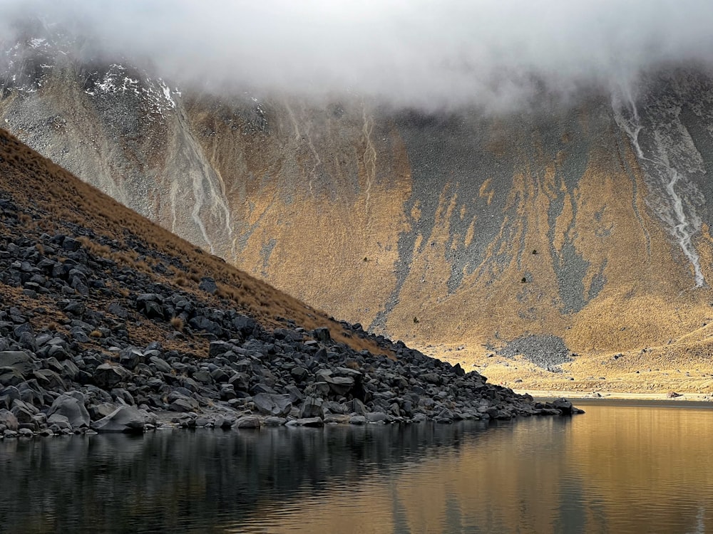 a body of water surrounded by rocky mountains