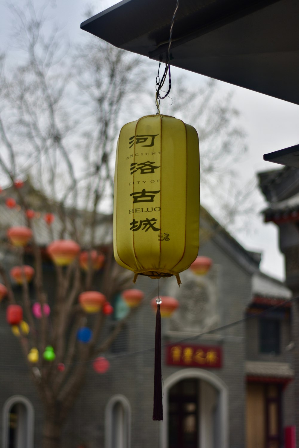 a yellow lantern hanging from the side of a building