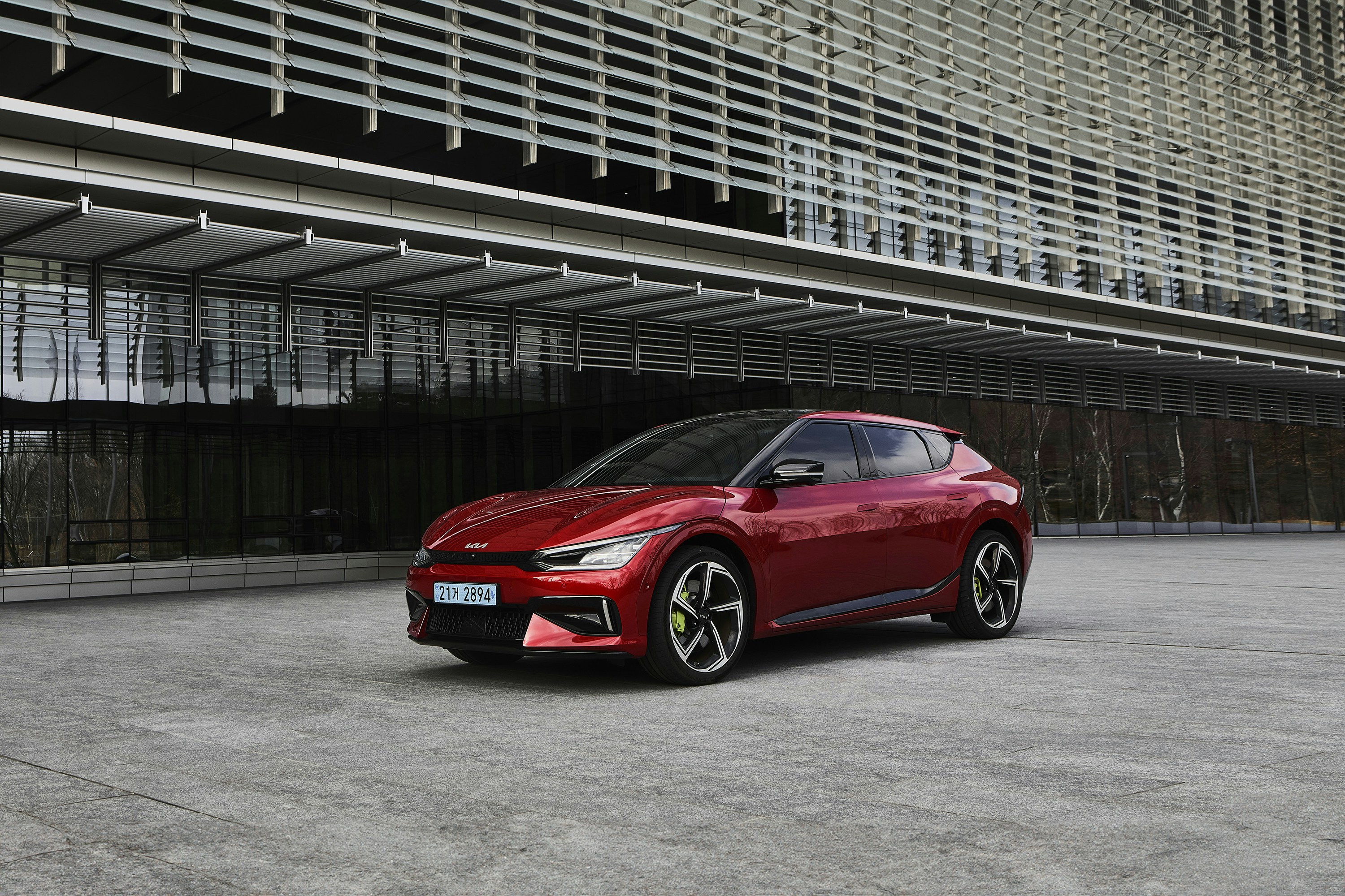 a red car parked in front of a building