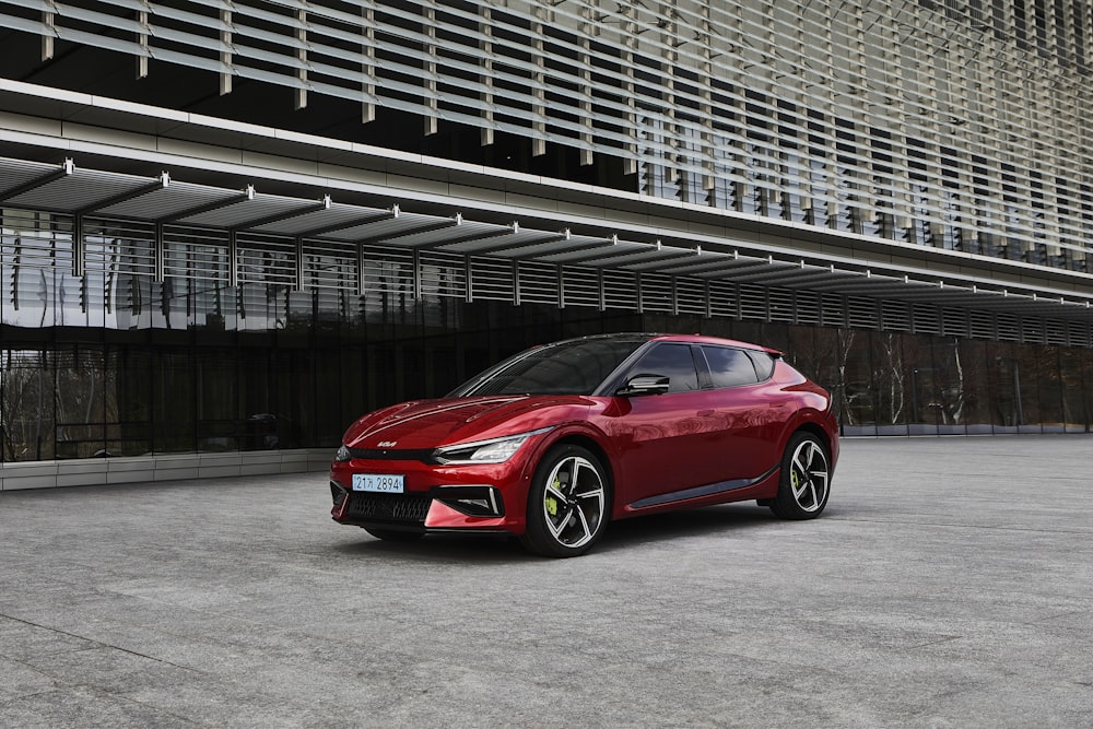 a red car parked in front of a building