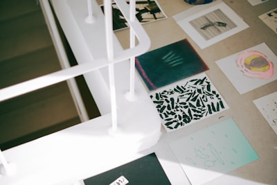 a desk with a lot of papers and pictures on it