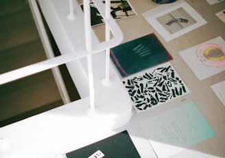 a desk with a lot of papers and pictures on it