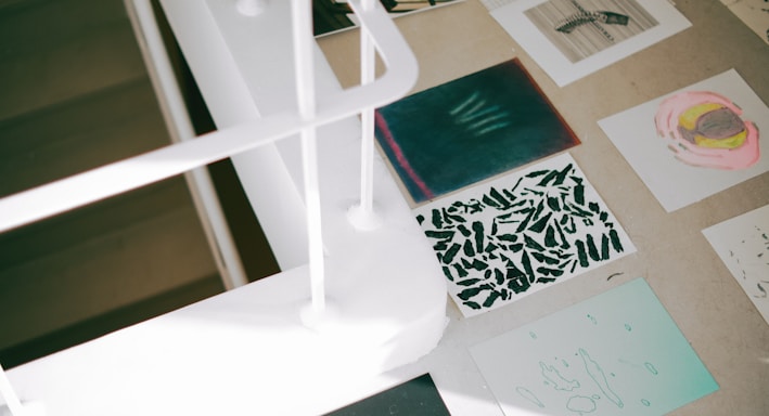 a desk with a lot of papers and pictures on it