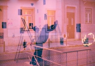 a blurry image of a person standing in front of a building