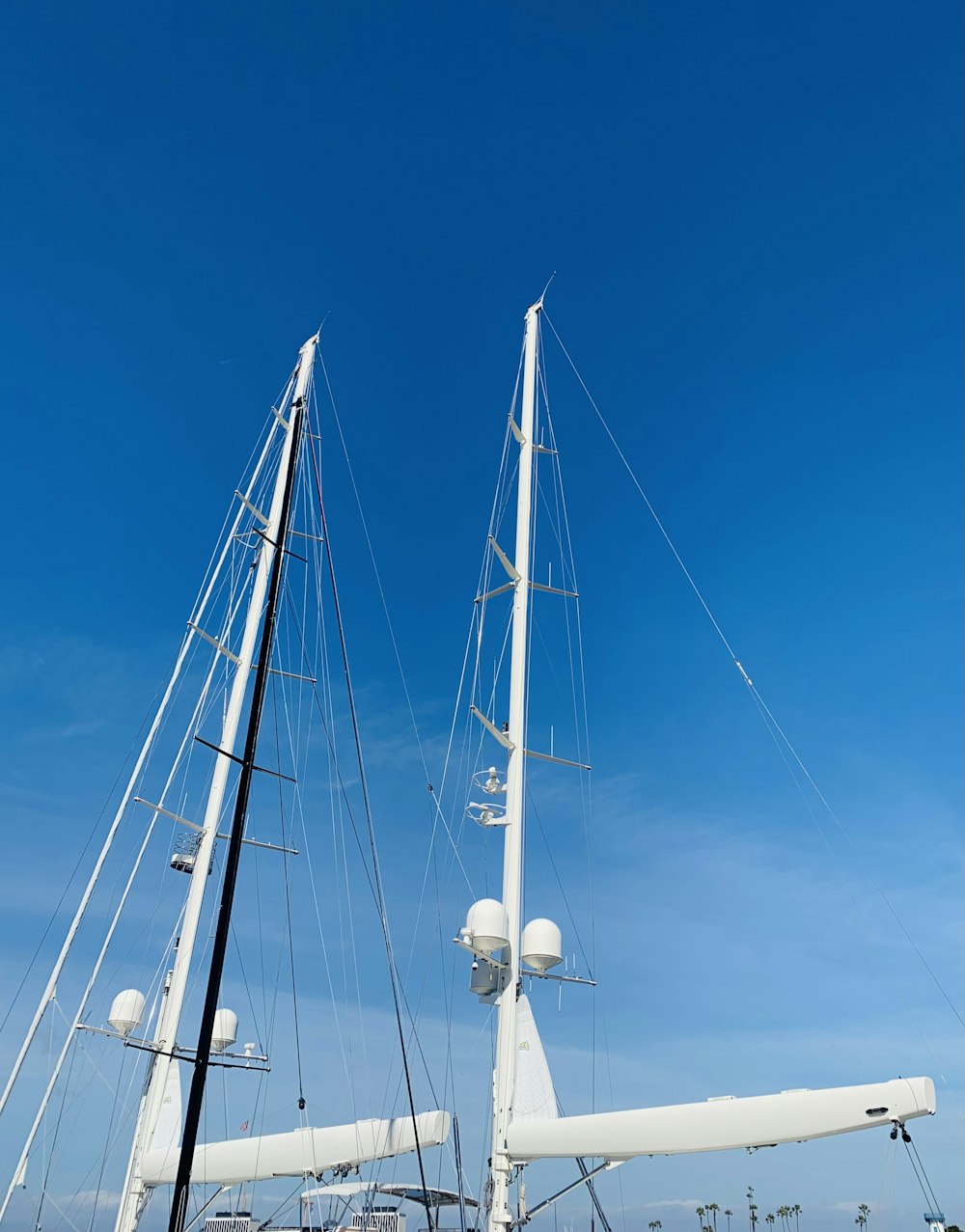 a white sailboat sitting on top of a body of water