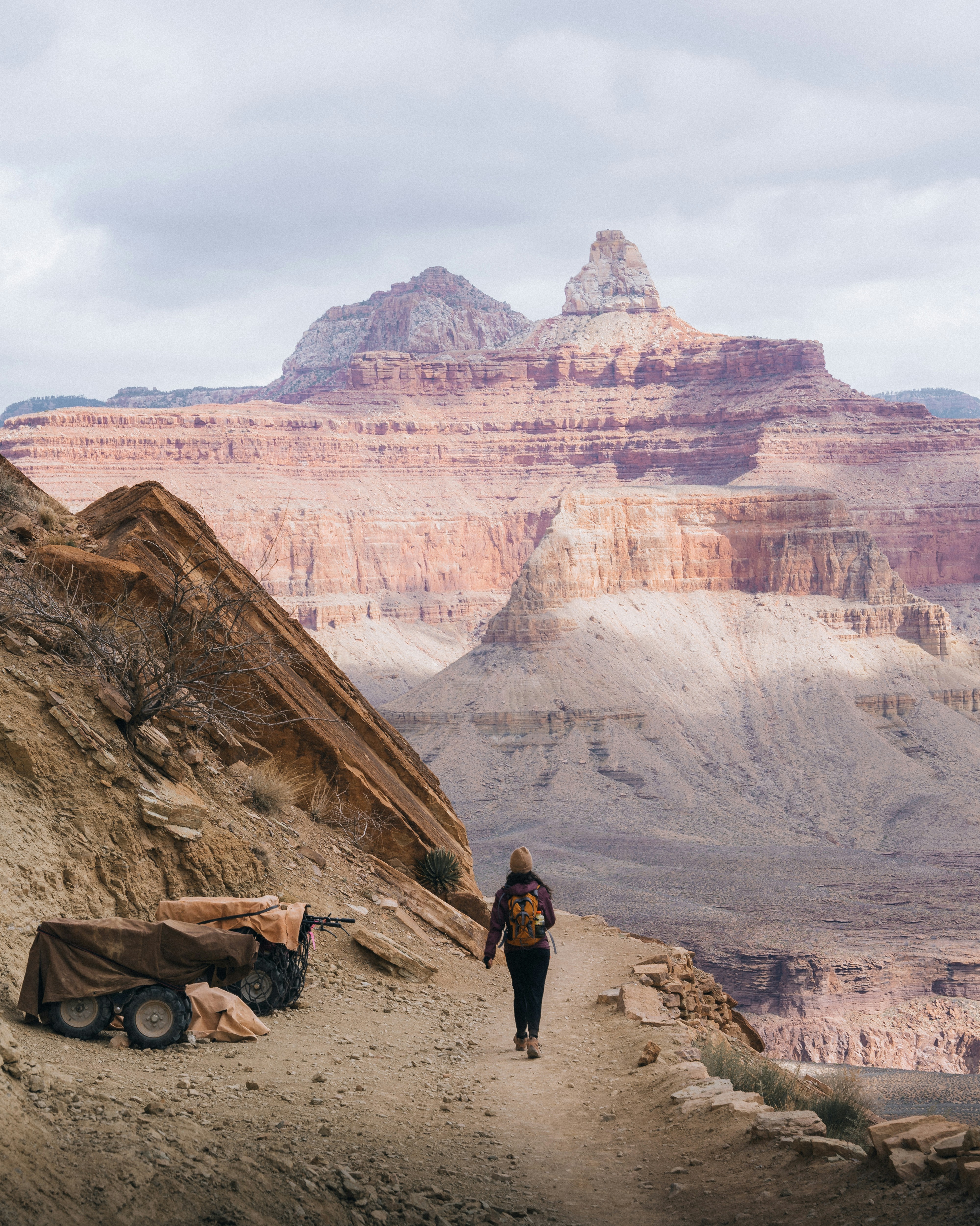a person walking up a trail in the mountains