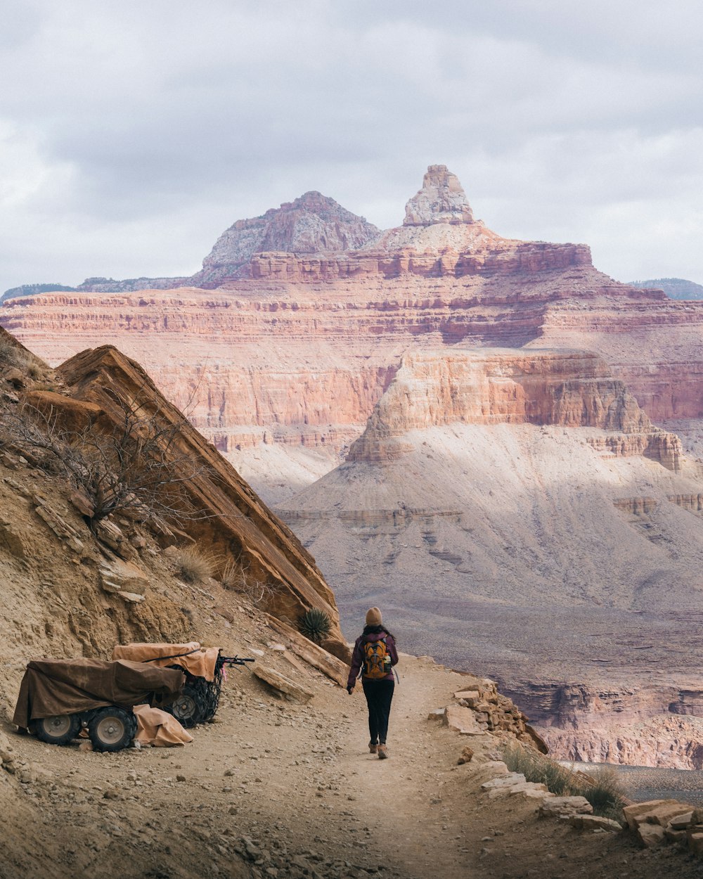 a person walking up a trail in the mountains