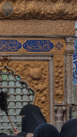 a woman in a black hijab standing in front of a building