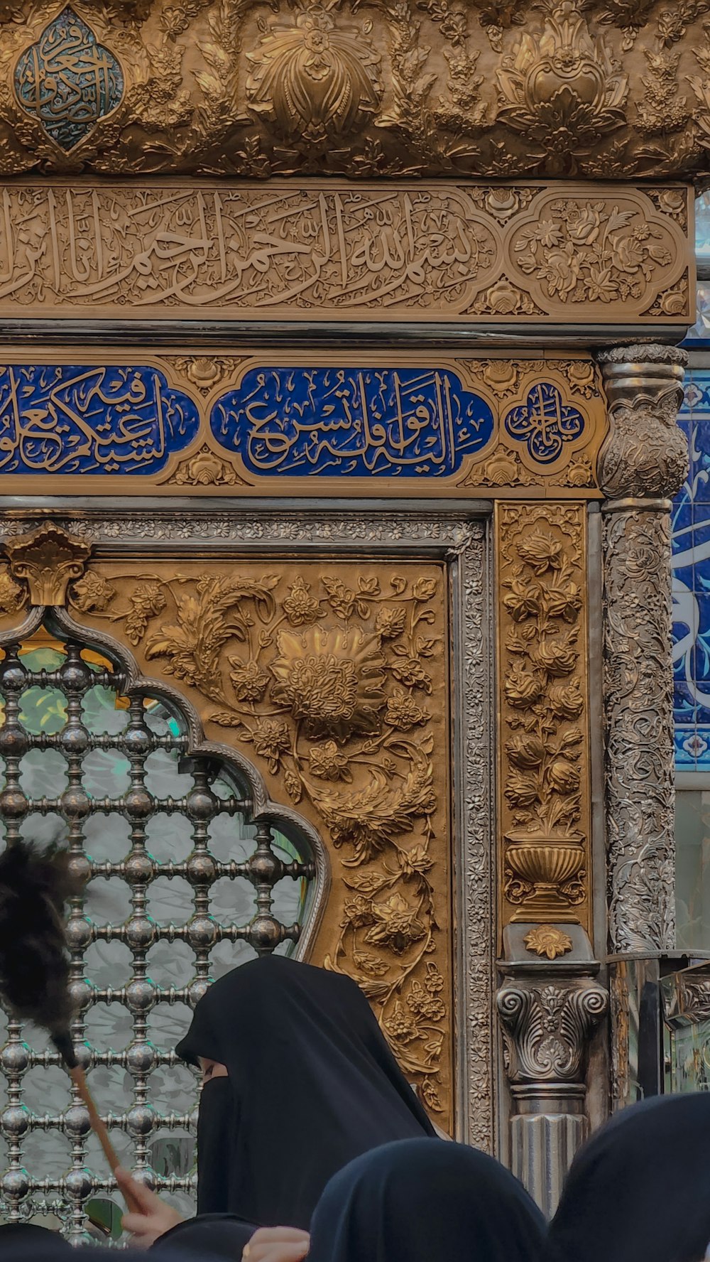 a woman in a black hijab standing in front of a building