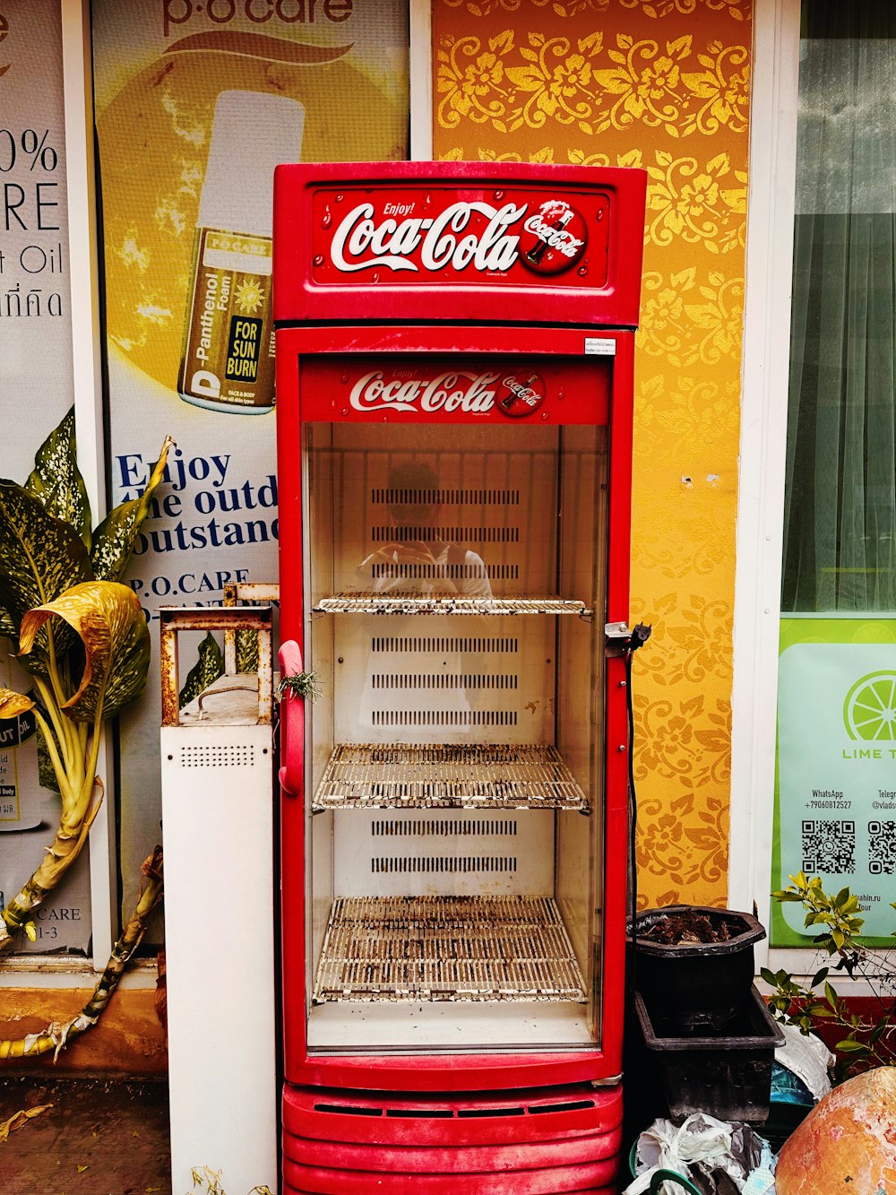 an old fashioned coca - cola vending machine sits in front of a store