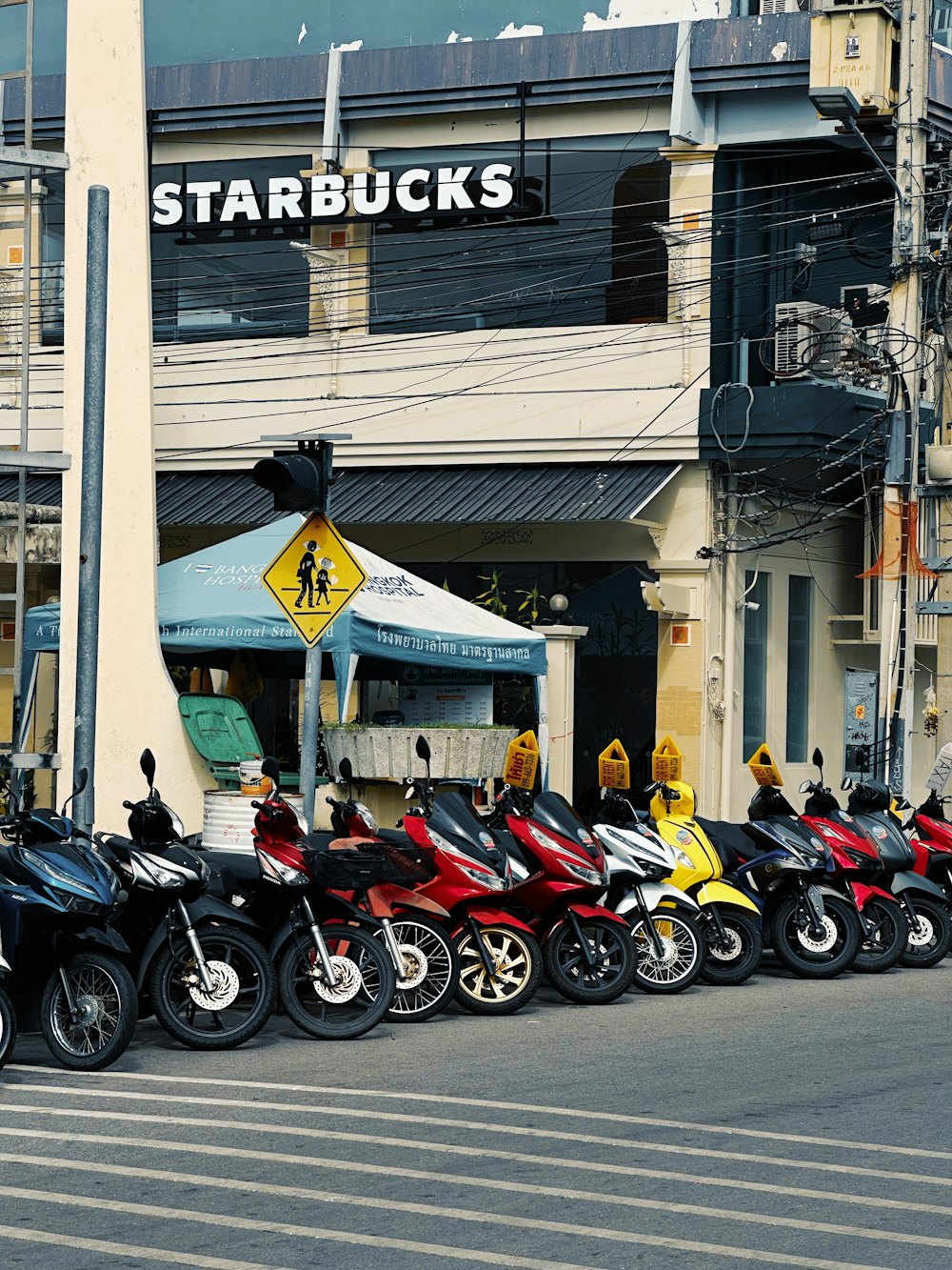 a row of motorcycles parked in front of a building