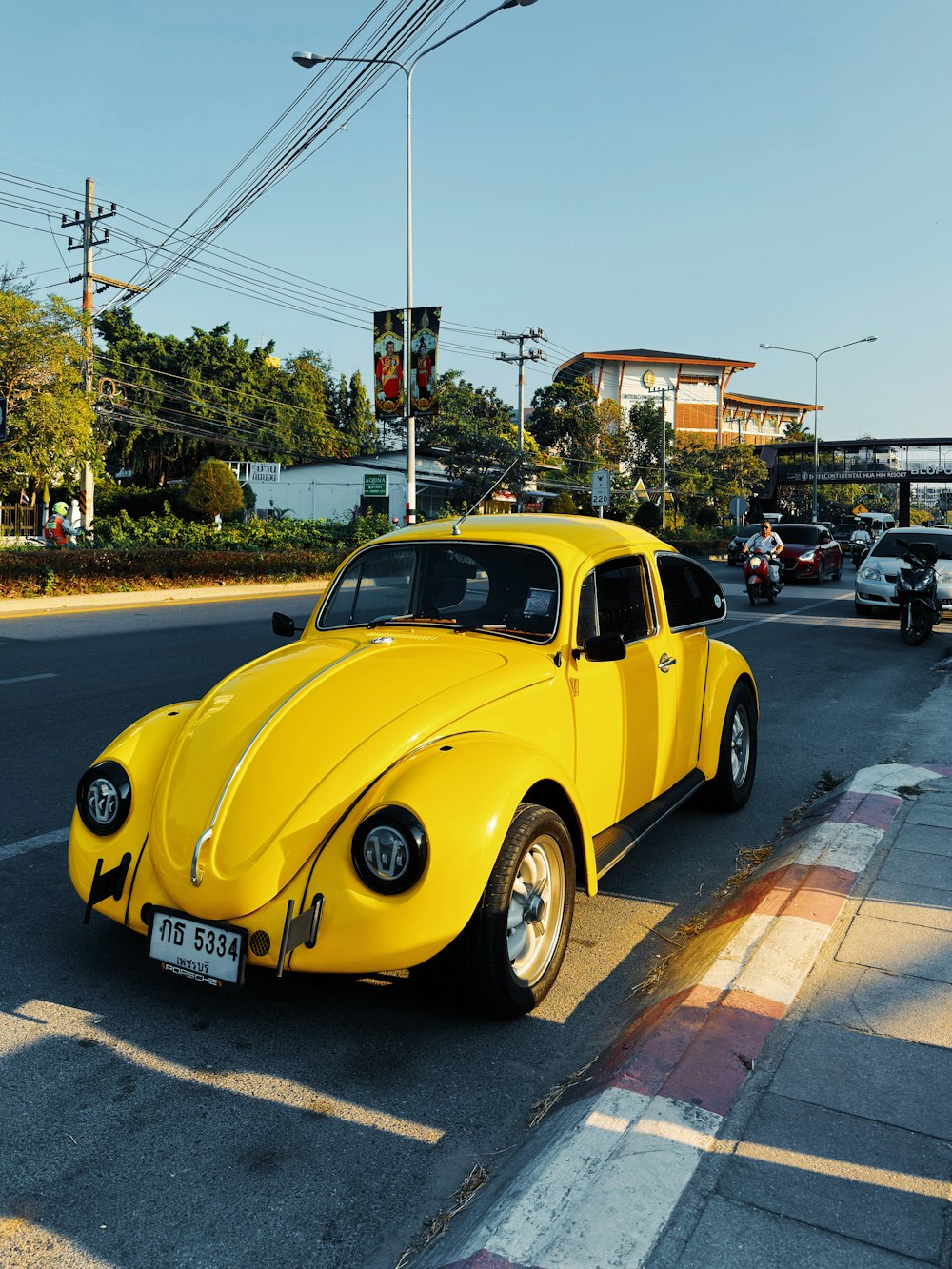 a yellow car parked on the side of the road