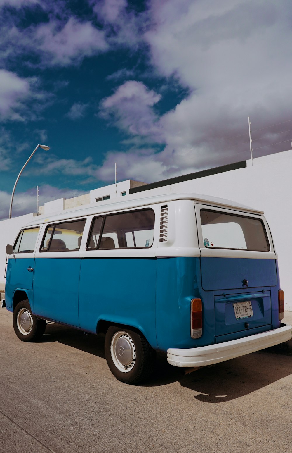 a blue and white van parked in front of a building