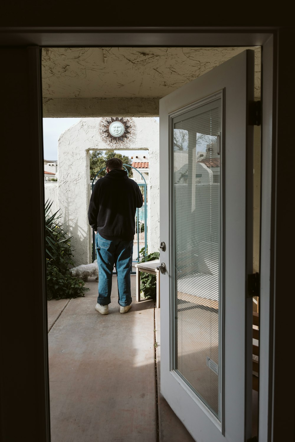 a man walking out of a door into a house