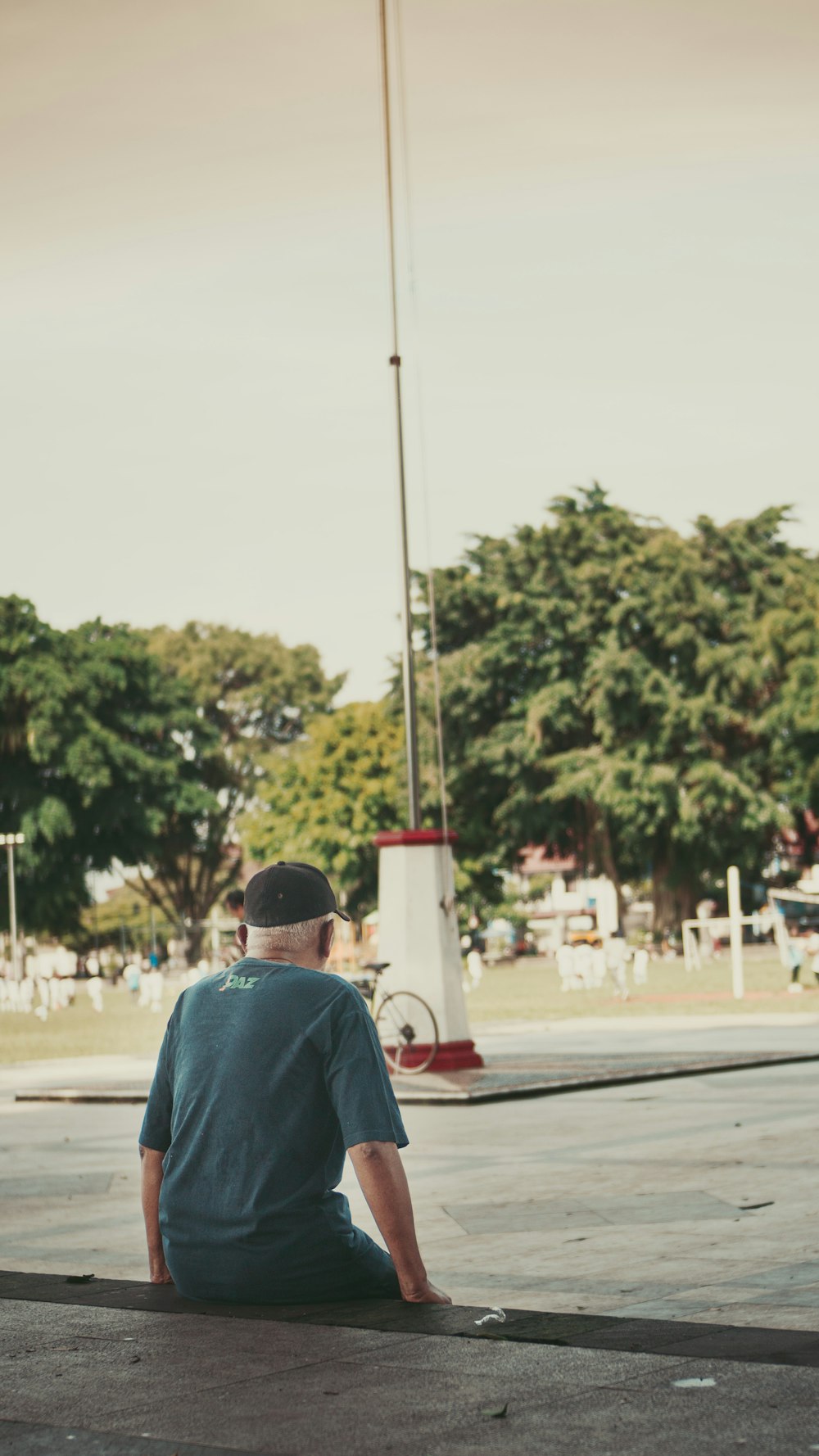 a man sitting on the ground with a skateboard