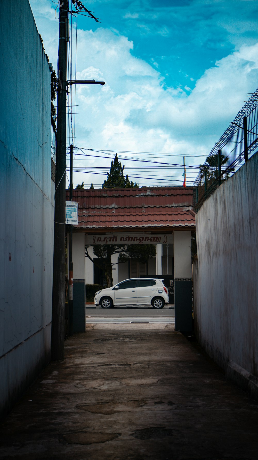 a white car is parked in an alley