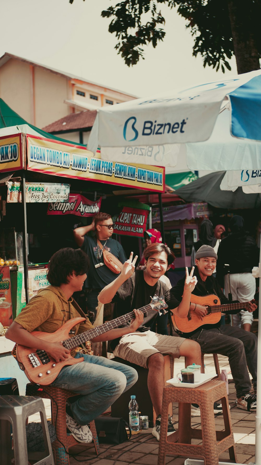 a group of people sitting around playing guitars