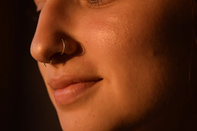 a close up of a woman with a nose piercing