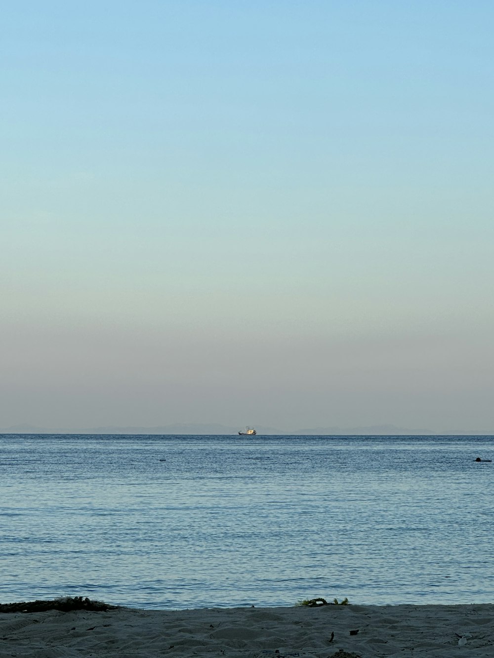 a person sitting on a bench looking out at the ocean