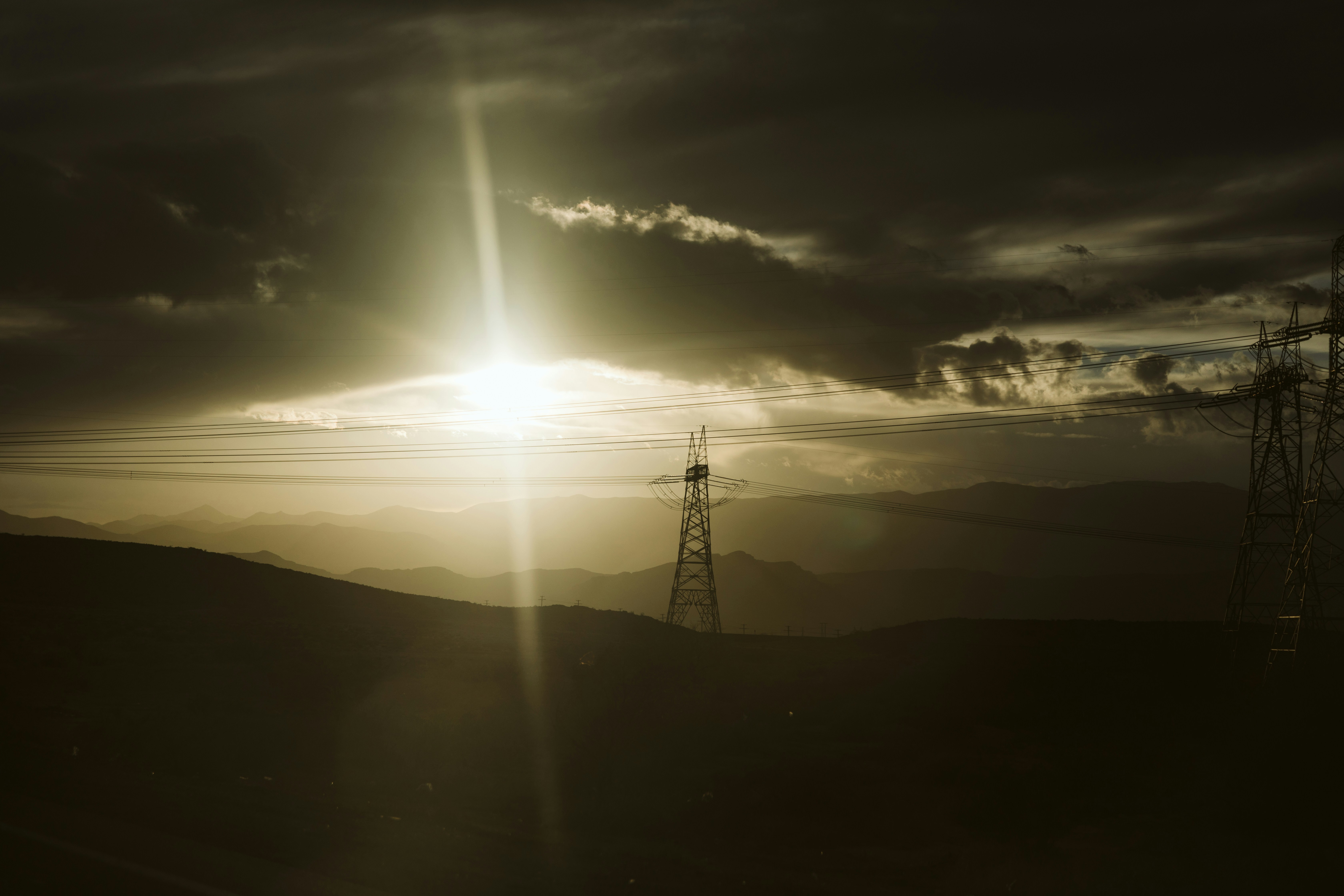 the sun is setting over a mountain range
