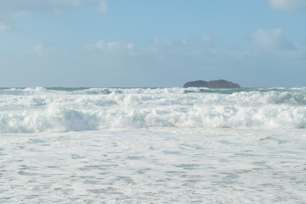 a person riding a surfboard on a wave in the ocean