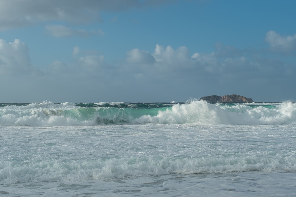 a large body of water with waves coming in to shore