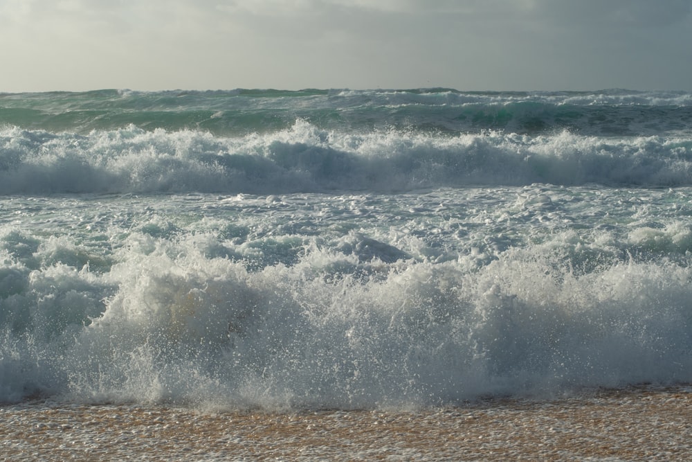 a large body of water next to a sandy beach