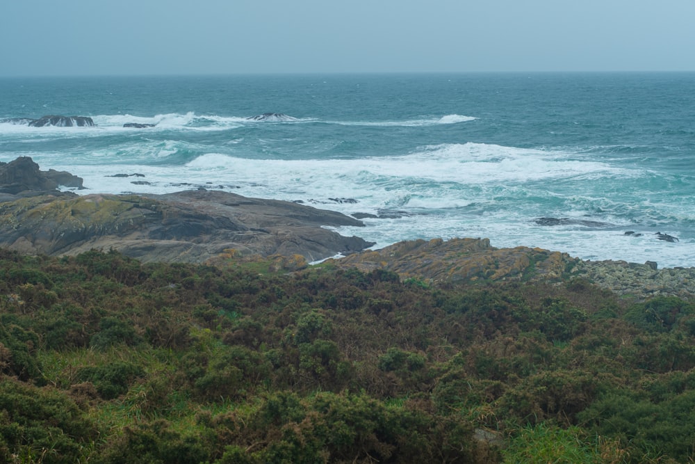 a view of the ocean from a rocky cliff