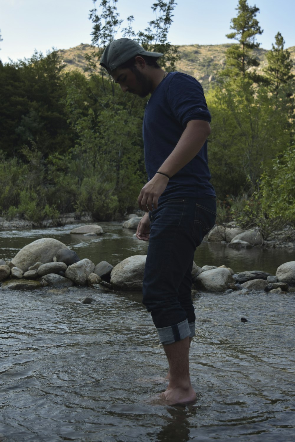 a man standing on a rock in a river