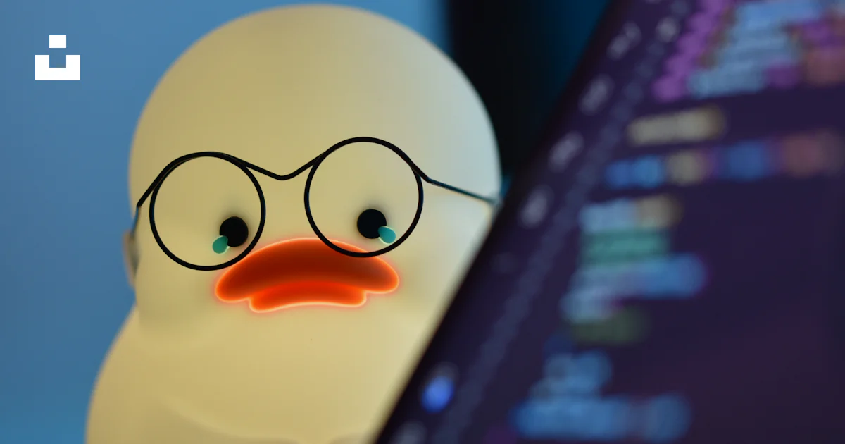 A rubber duck wearing glasses next to a computer photo – Free ...