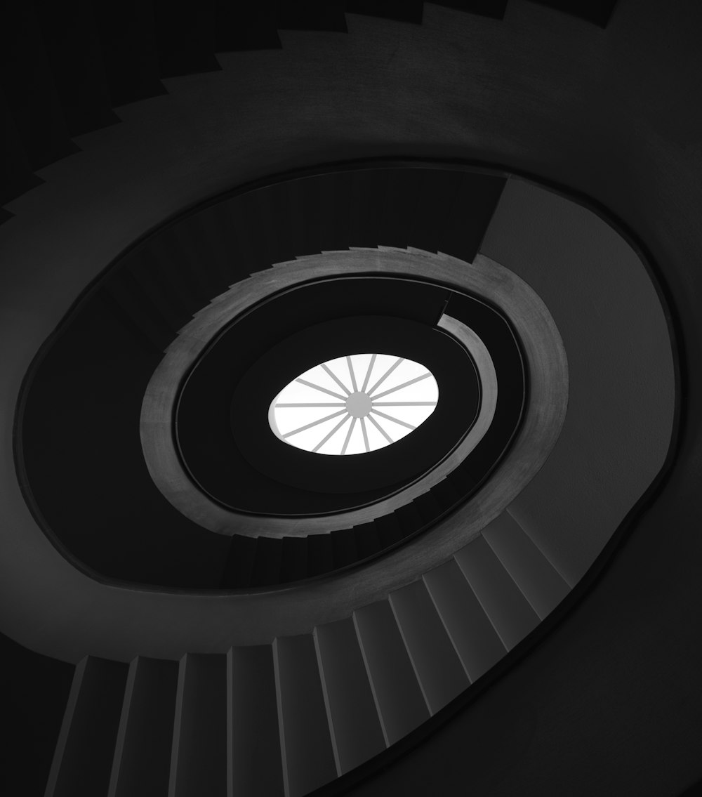 a black and white photo of a spiral staircase