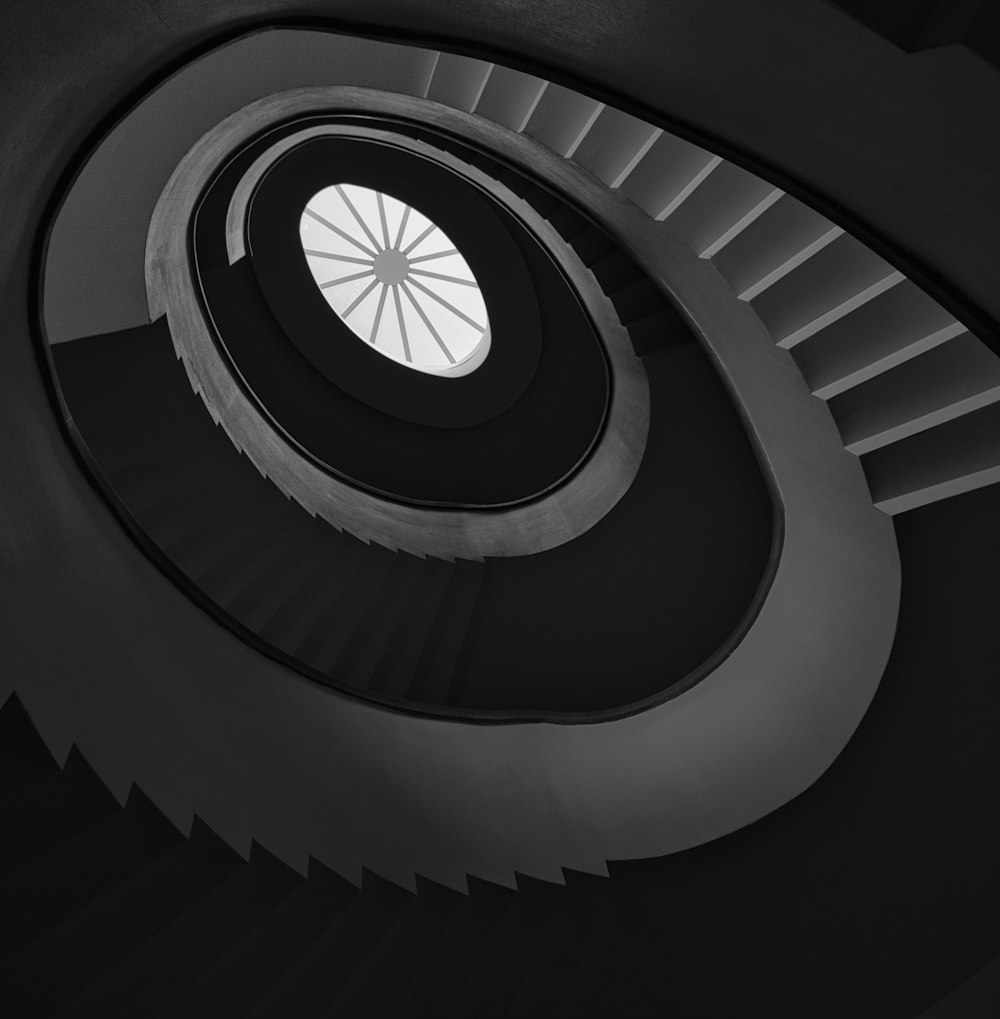 a black and white photo of a spiral staircase