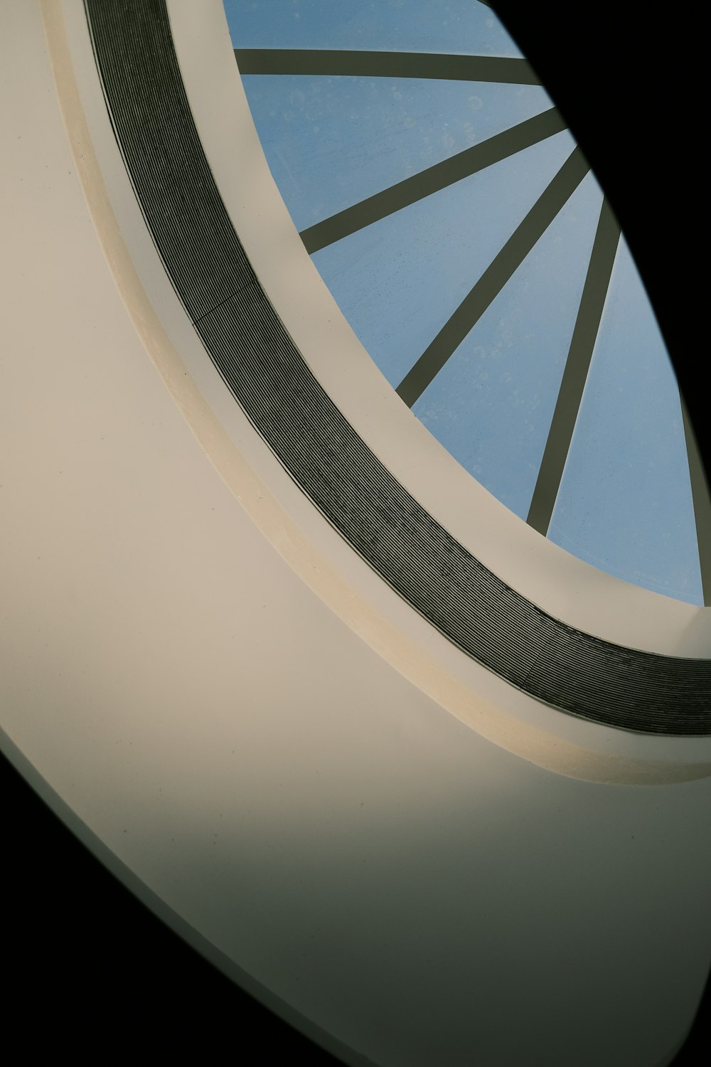 a circular window with a blue sky in the background
