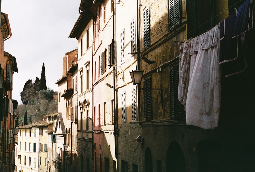 a narrow street with clothes hanging out to dry