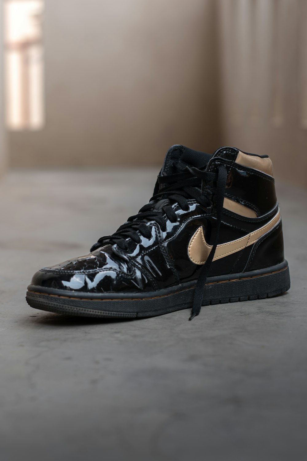a pair of black and gold nike sneakers