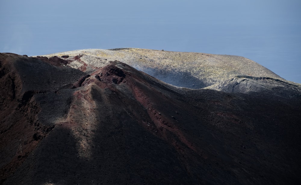 a mountain covered in brown and white snow