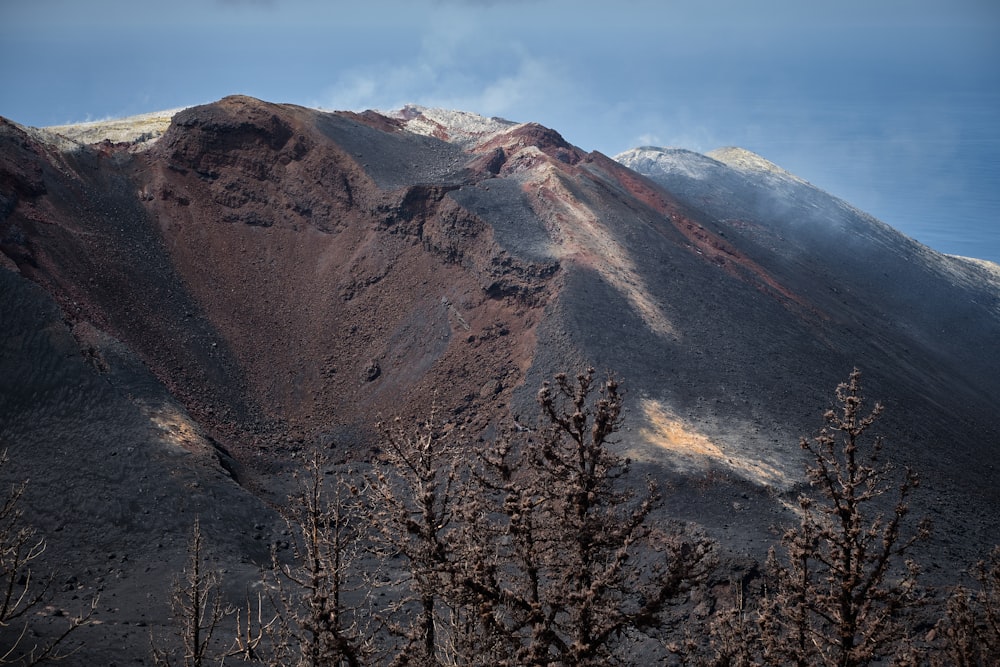 a view of the top of a mountain with clouds in the sky