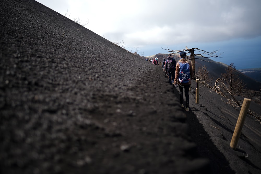 a group of people walking up a hill