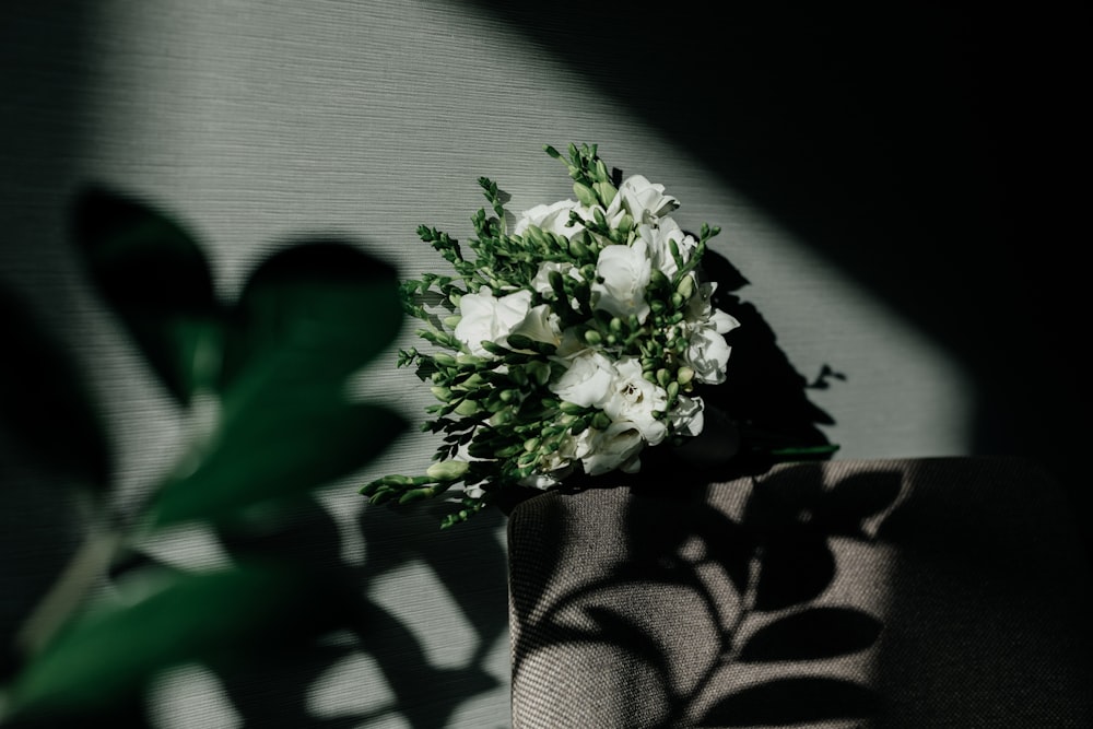 a bouquet of white flowers sitting on top of a table