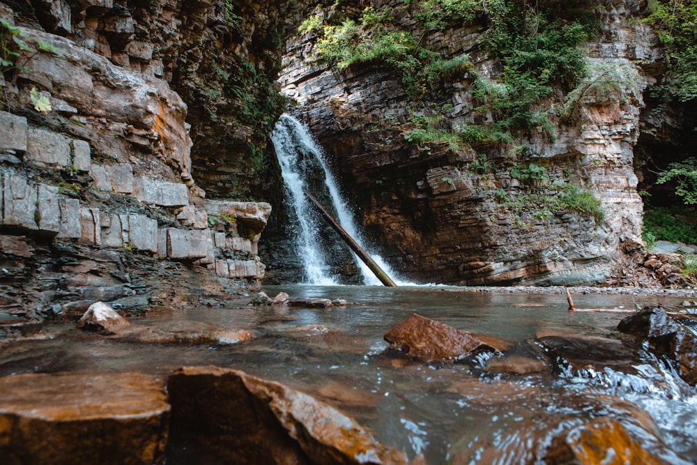 a small waterfall in the middle of a canyon