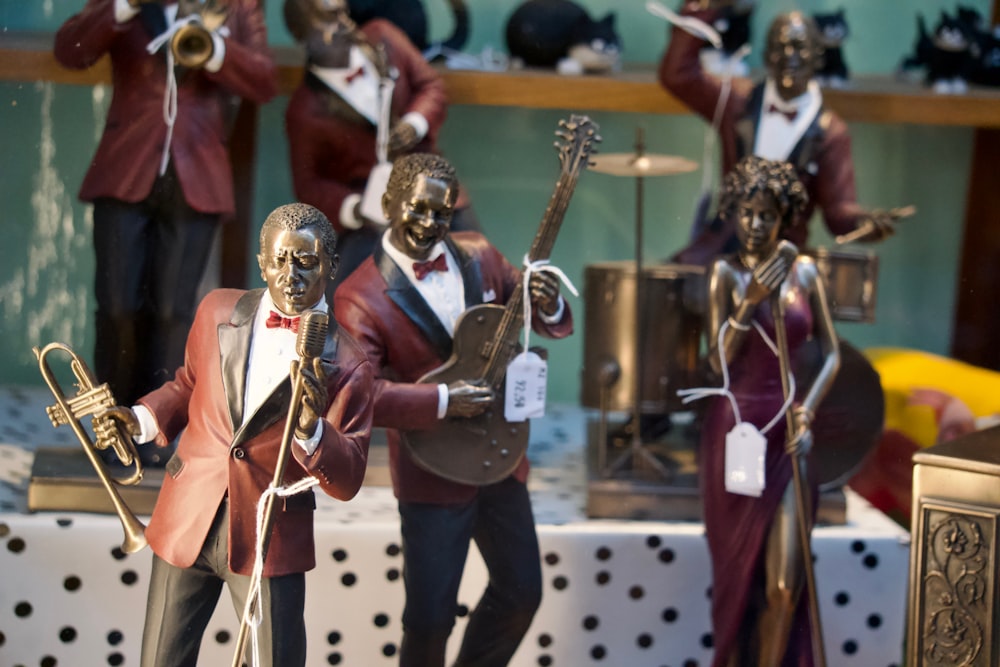 a group of figurines of men with musical instruments