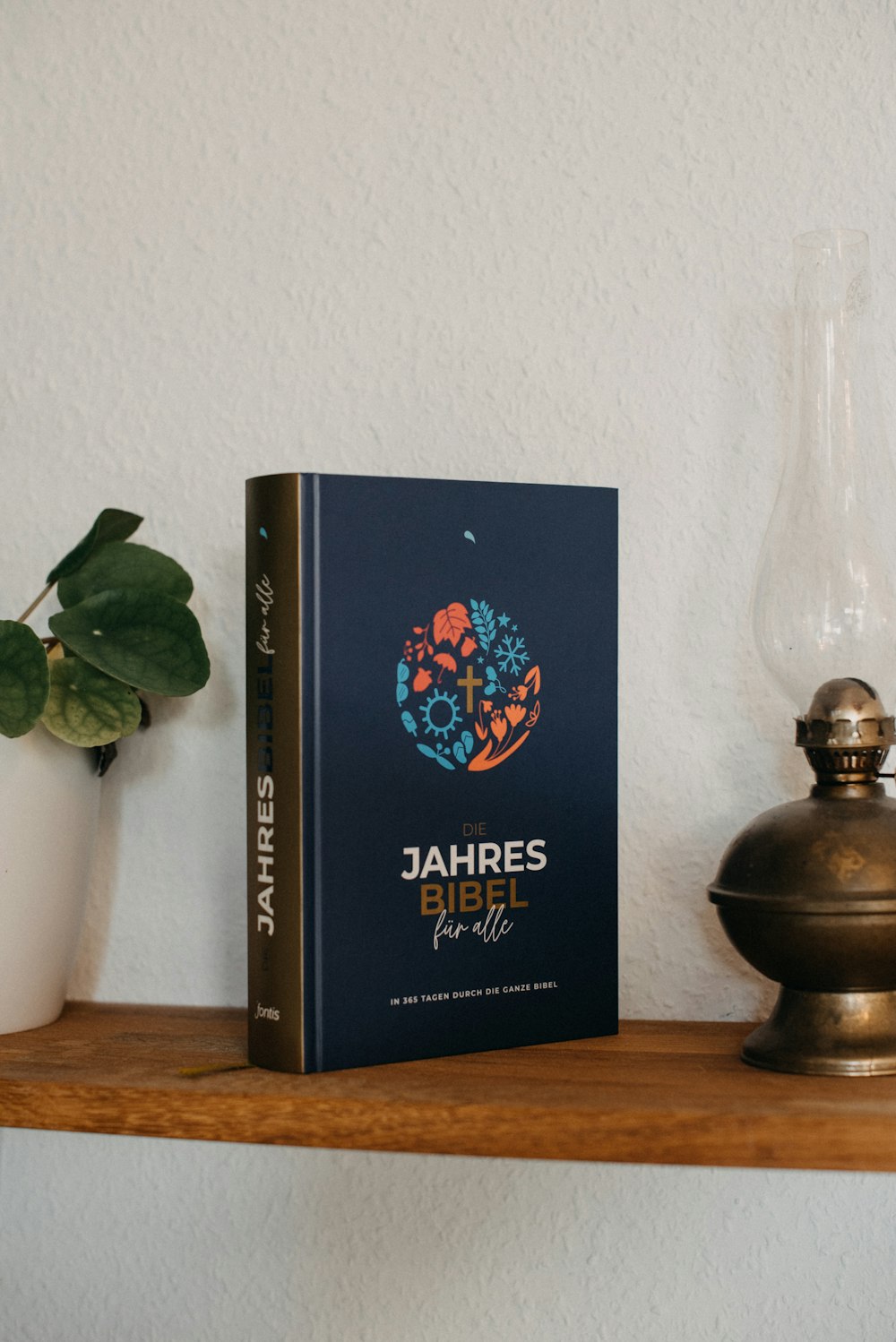 a book sitting on top of a wooden shelf