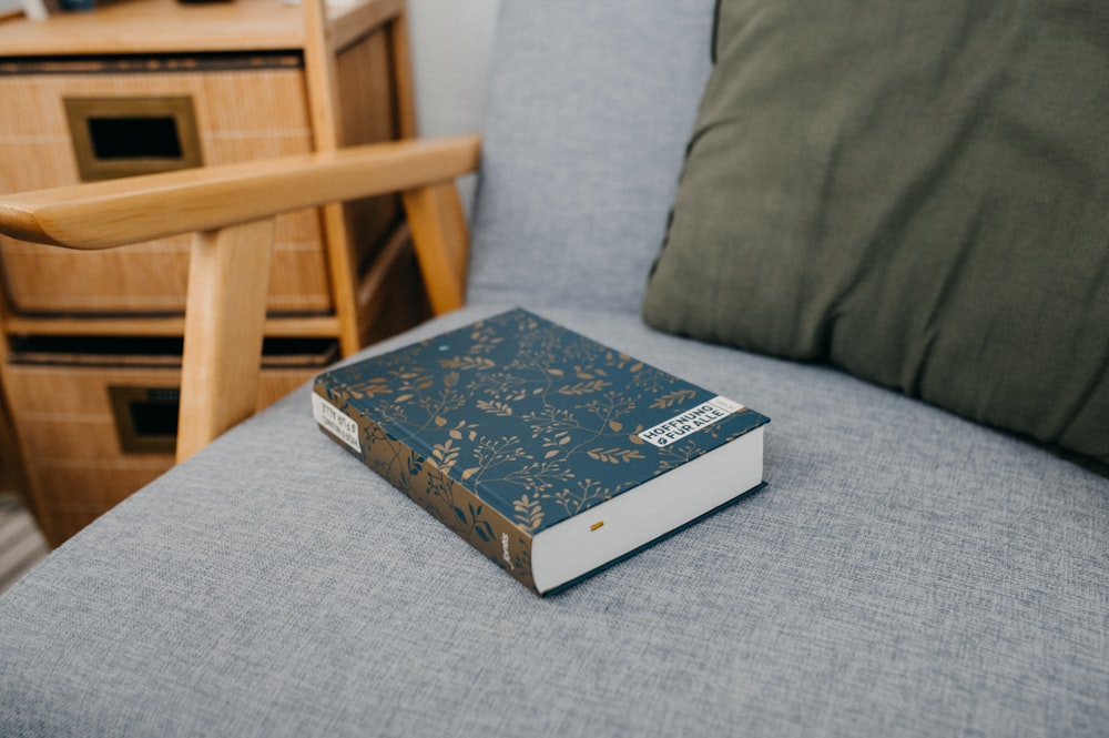 a book sitting on top of a blue couch