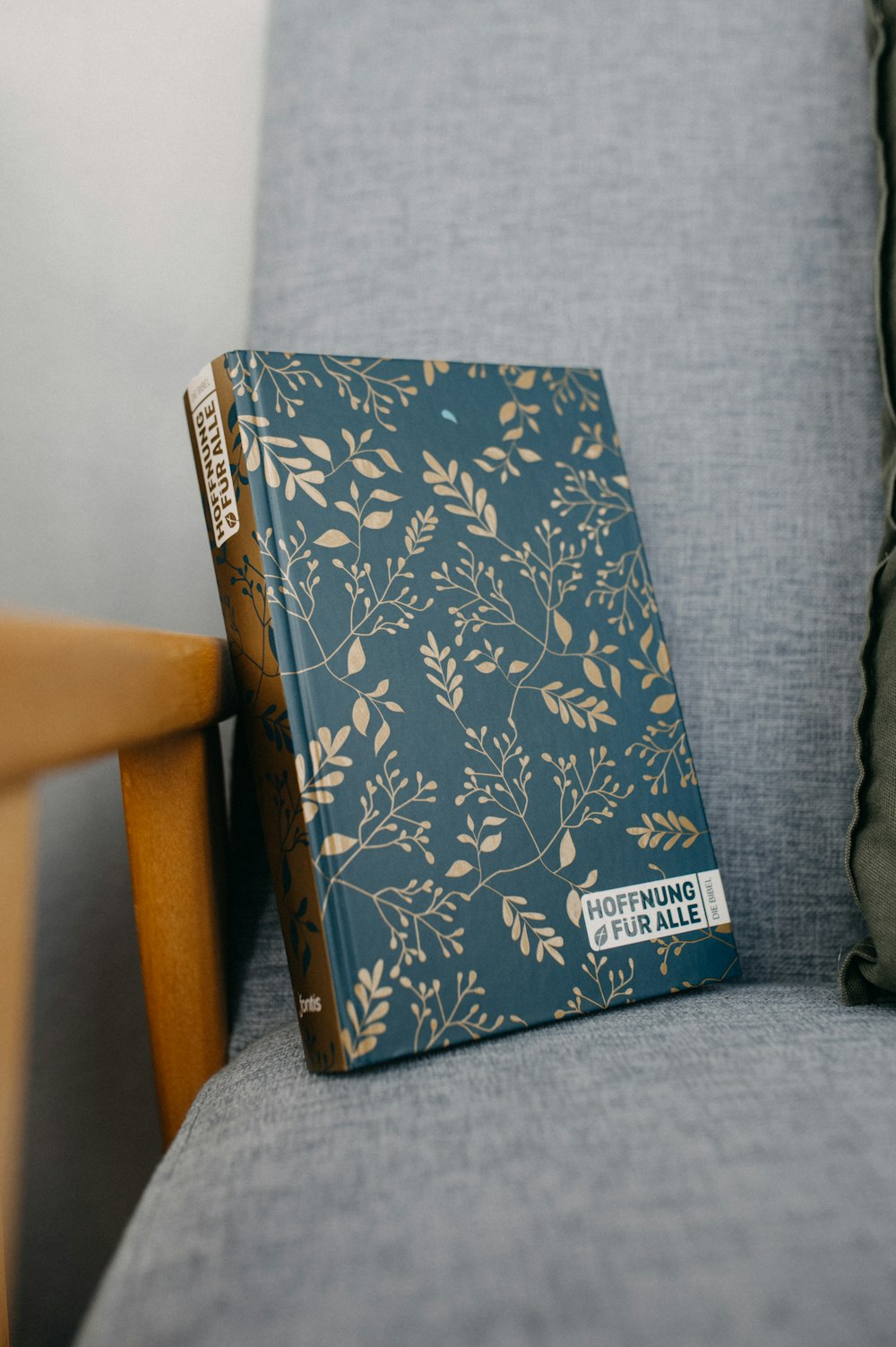 a book sitting on top of a blue couch