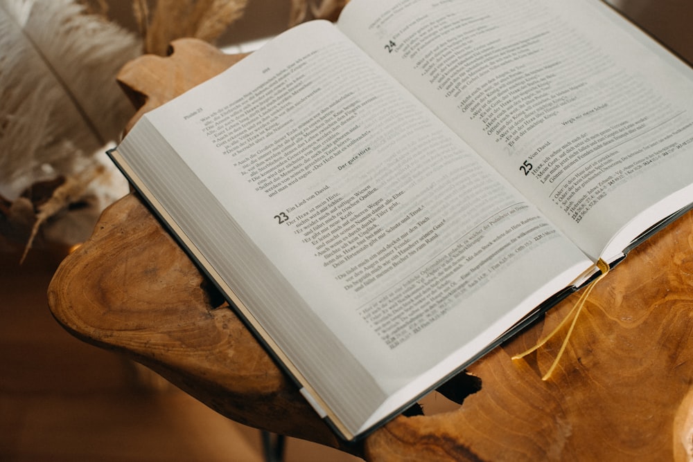 an open book sitting on top of a wooden table