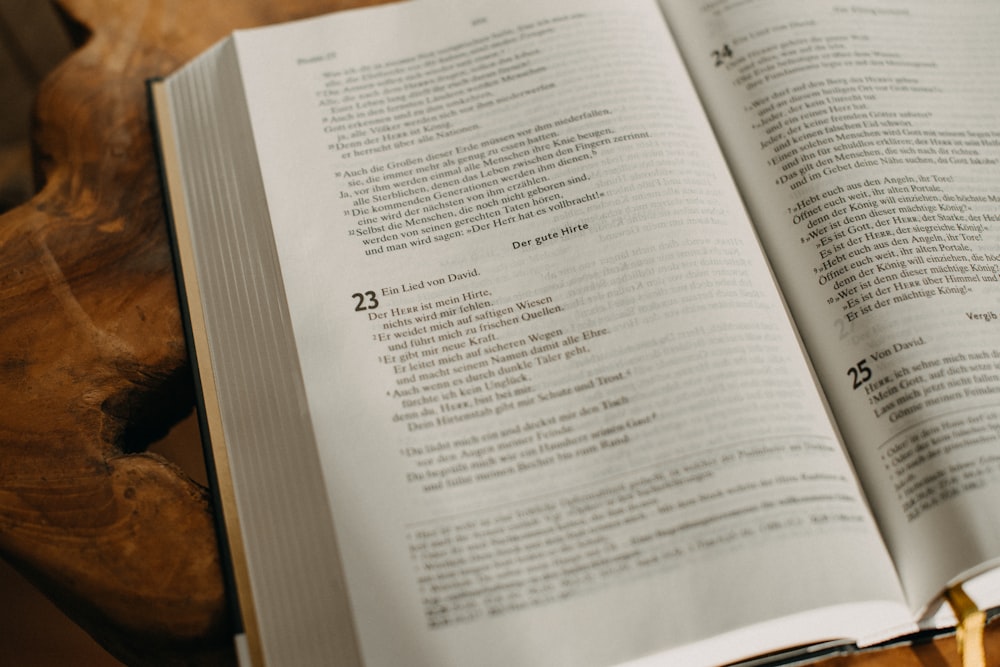 an open book sitting on top of a wooden table